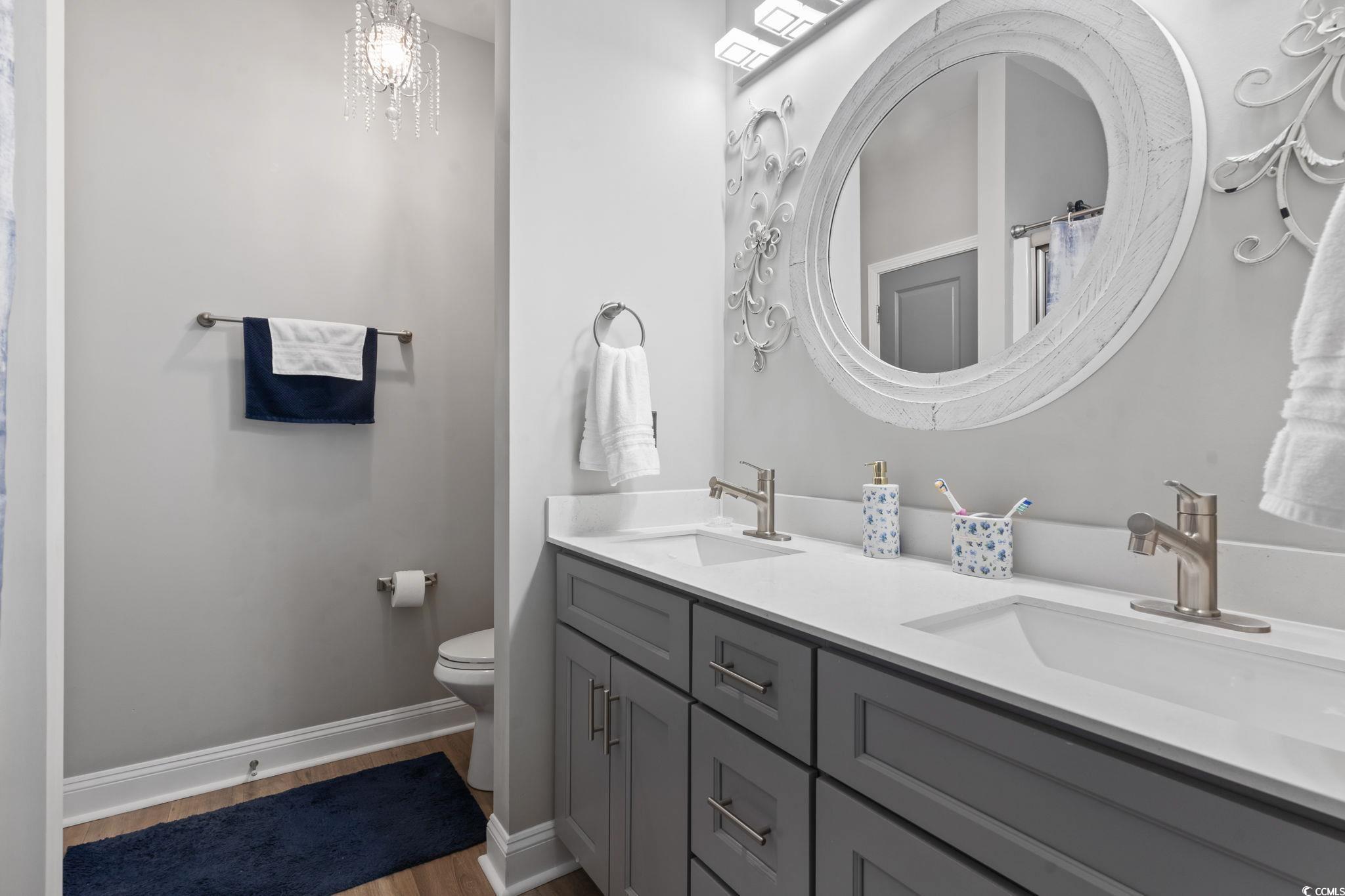 804 Twickenham Loop Longs, SC 29568 - Photo 16 of 26 Full bathroom with light wood-style floors and double vanity