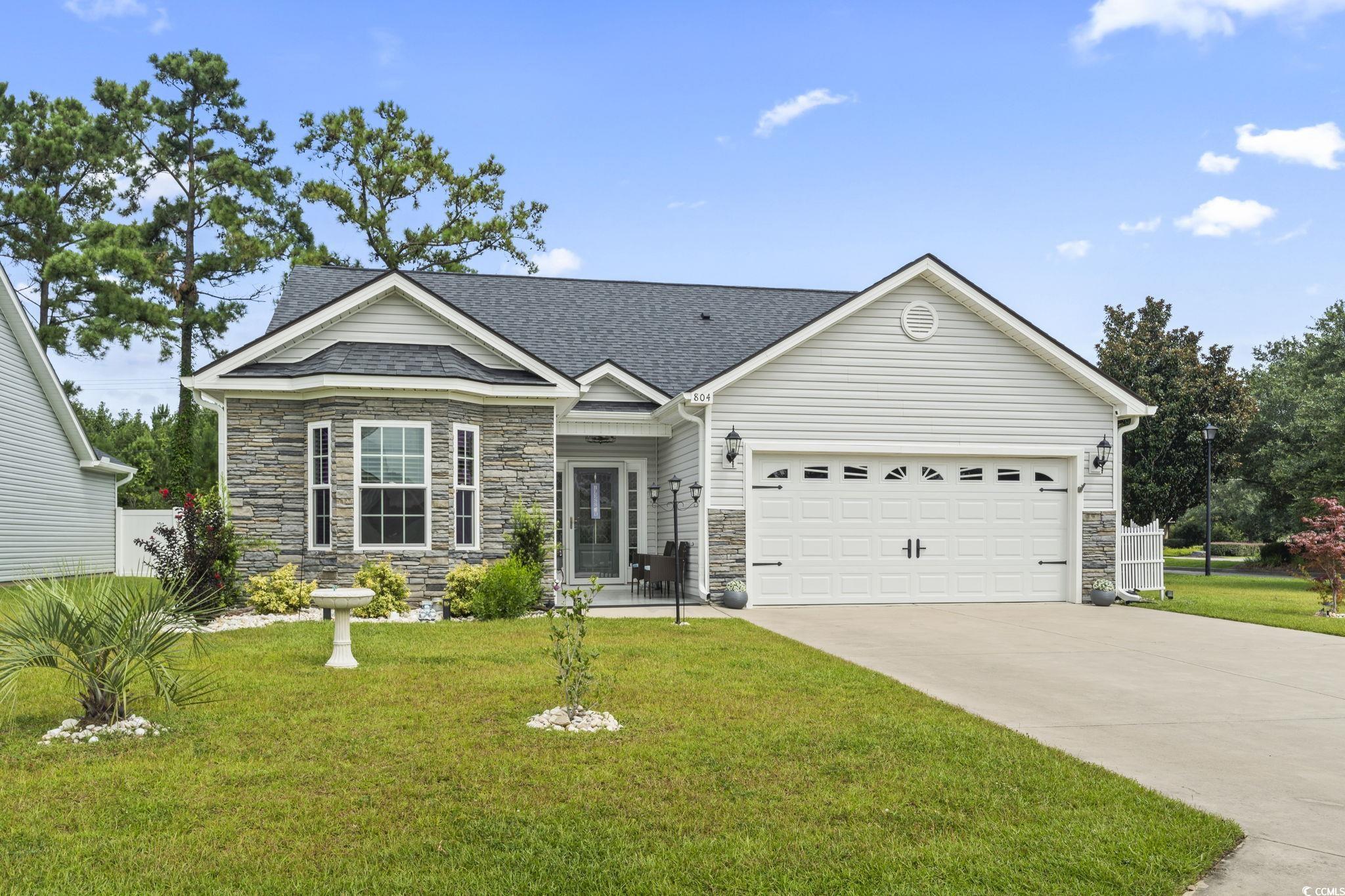 804 Twickenham Loop Longs, SC 29568 - Photo 2 of 26 View of front of home featuring stone siding, driveway, a garage, and roof with shingles