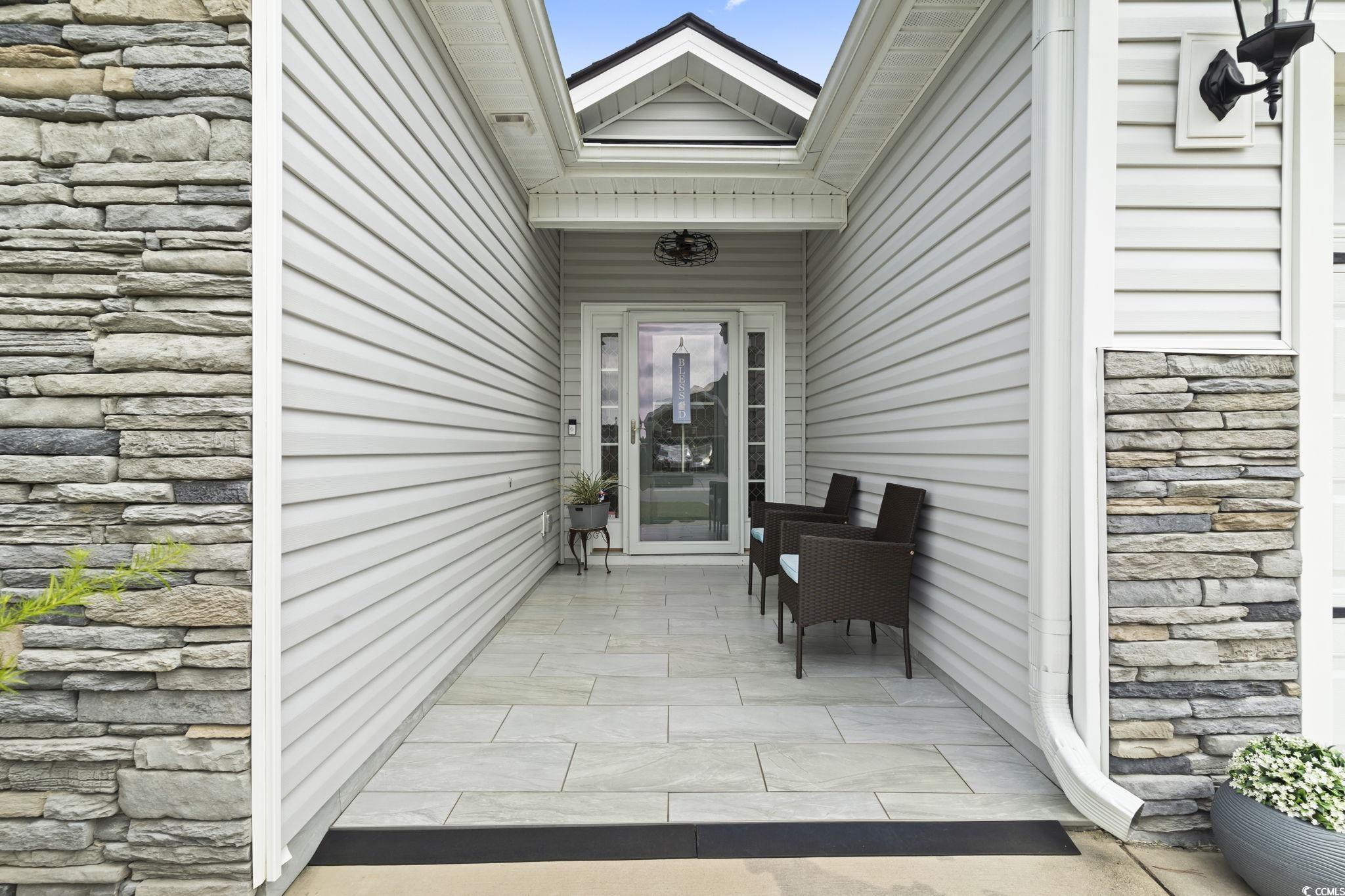 804 Twickenham Loop Longs, SC 29568 - Photo 4 of 26 Doorway to property with stone siding and a patio