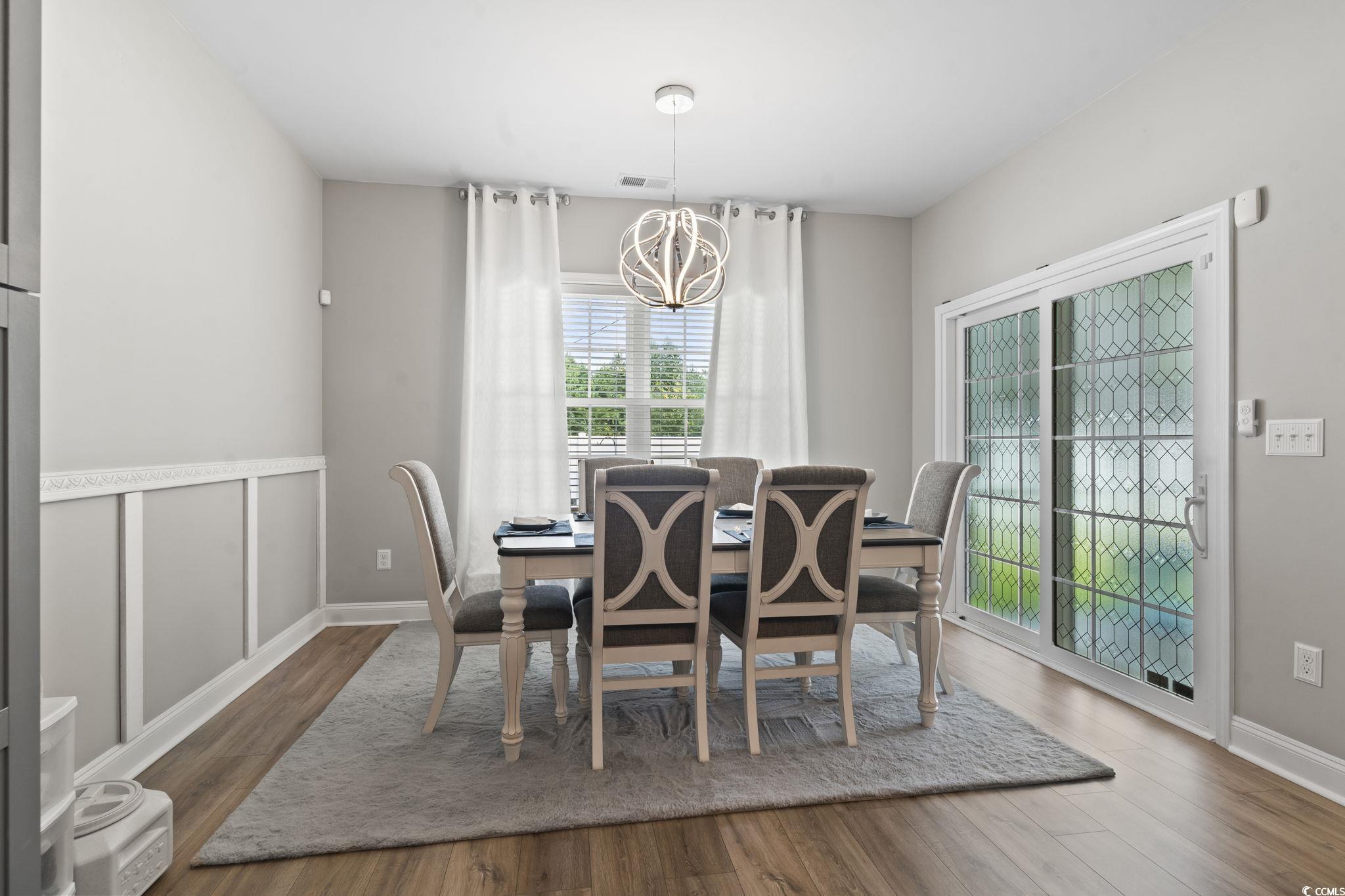 804 Twickenham Loop Longs, SC 29568 - Photo 8 of 26 Dining space with a chandelier and wood finished floors