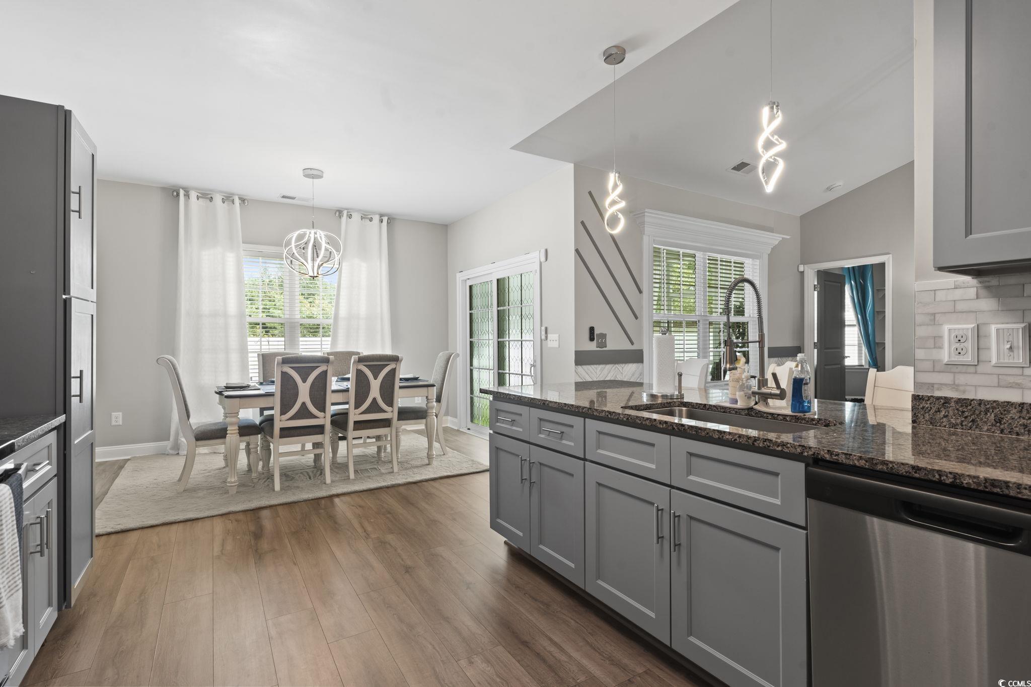 804 Twickenham Loop Longs, SC 29568 - Photo 9 of 26 Kitchen featuring gray cabinetry, a peninsula, dishwasher, dark stone counters, and hanging light fixtures