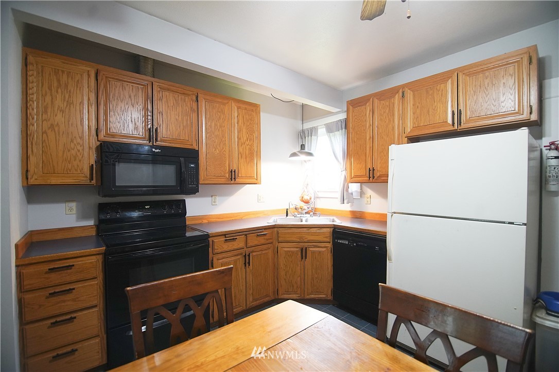 12910 Trout Farm Road Sultan, WA 98294 - Photo 8 of 20 a kitchen with a refrigerator and a sink