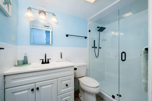 a bathroom with a sink a toilet and a mirror