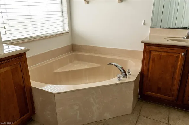 a bath tub sitting in a bathroom next to a window