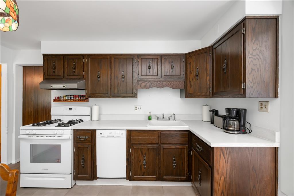 411 Harmony Road Baden, PA 15005 - Photo 10 of 25 a kitchen with stainless steel appliances a stove a sink a refrigerator and cabinets