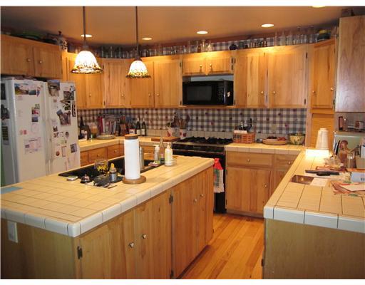 260 Castile Ridge Road Clarksville, PA 15345 - Photo 6 of 16 Kitchen. Solid hickory kitchen cabinetry and hickory flooring w/tile countertops; w/center island; with professional chef oven
