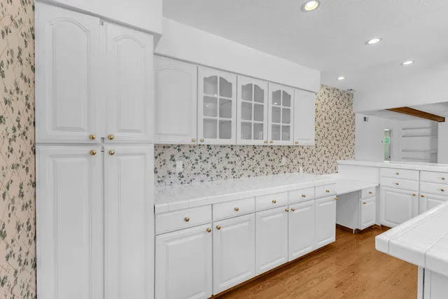 a view of a kitchen with white cabinets