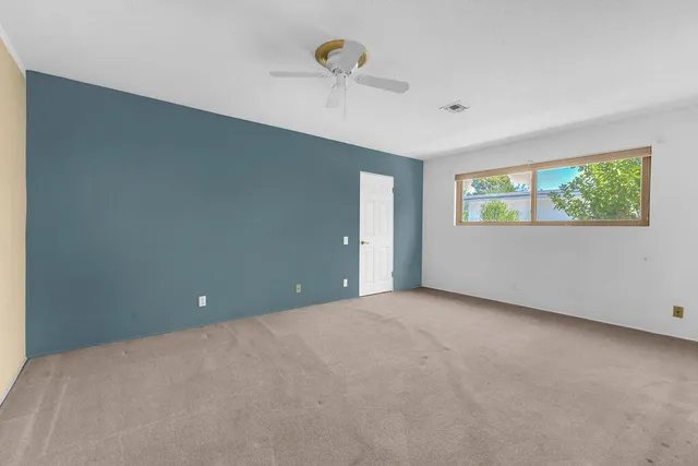 an empty room with windows and closet