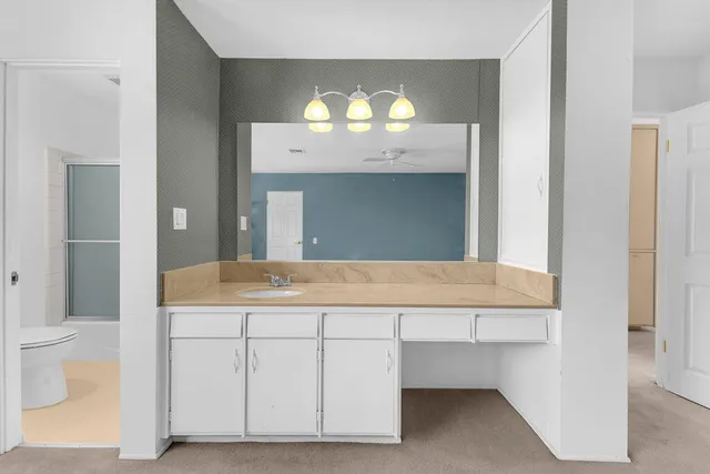 a room with kitchen island a sink and a stove