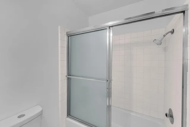 a bathroom with a glass shower door