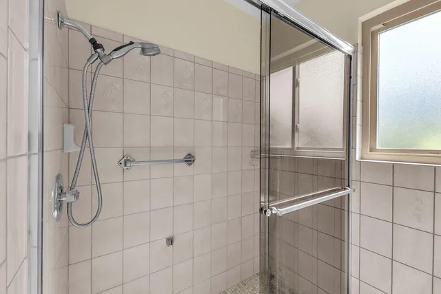 a bathroom that has a glass shower door