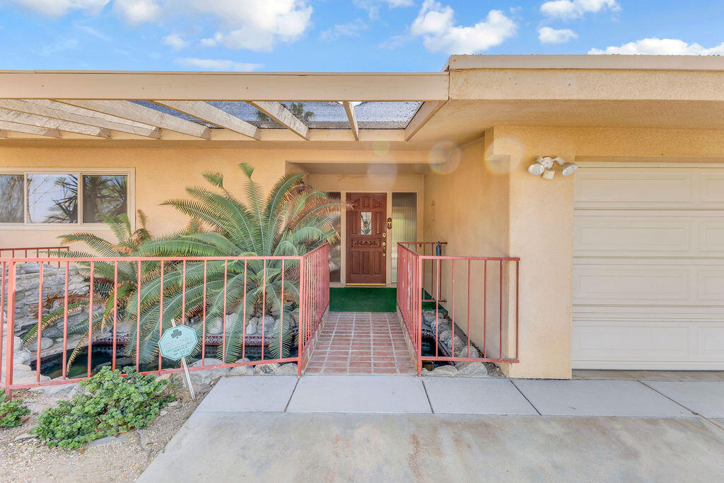 74075 Setting Sun Trail Palm Desert, CA 92260 - Photo 3 of 52 a view of a house with a porch