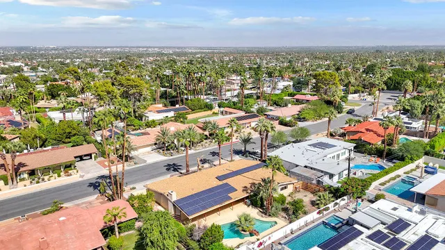 an aerial view of residential house and sandy dunes