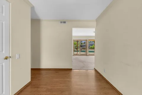 a view of an empty room with a fireplace and a window