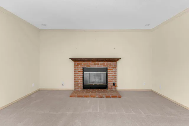 a view of an empty room with a fireplace