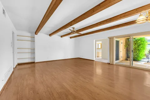 an empty room with wooden floor and door