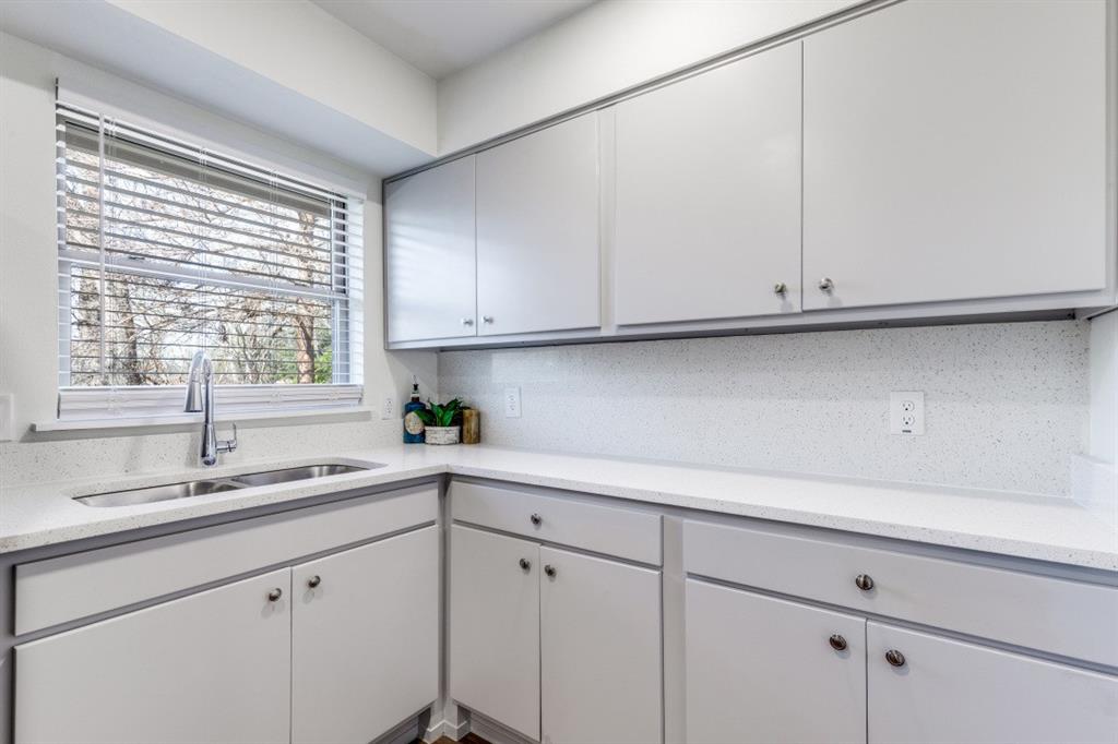 2663 Springvale Drive Farmers Branch, TX 75234 - Photo 11 of 25 a kitchen with white cabinets and a window
