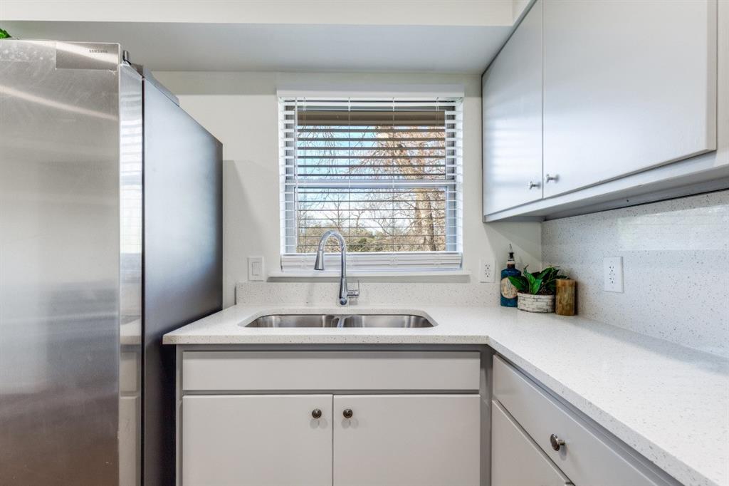 2663 Springvale Drive Farmers Branch, TX 75234 - Photo 12 of 25 a kitchen with a sink and a window