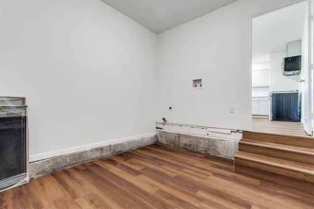 a view of a livingroom with an empty space and a fireplace