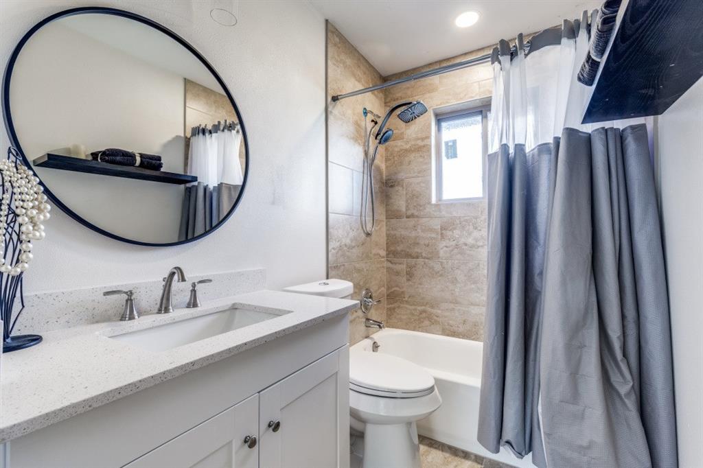 2663 Springvale Drive Farmers Branch, TX 75234 - Photo 21 of 25 a bathroom with a sink a toilet and a mirror
