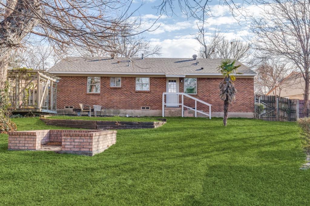 2663 Springvale Drive Farmers Branch, TX 75234 - Photo 24 of 25 a front view of a house with a garden