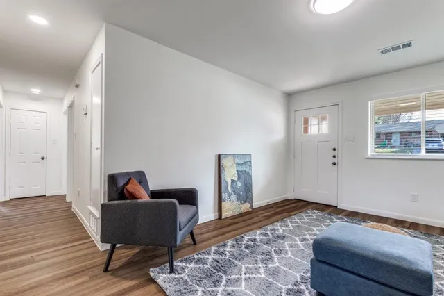 a bed room with a bed and a chair