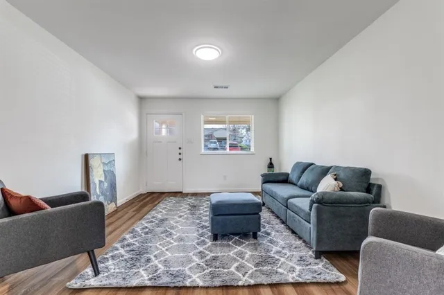 a living room with furniture and a rug