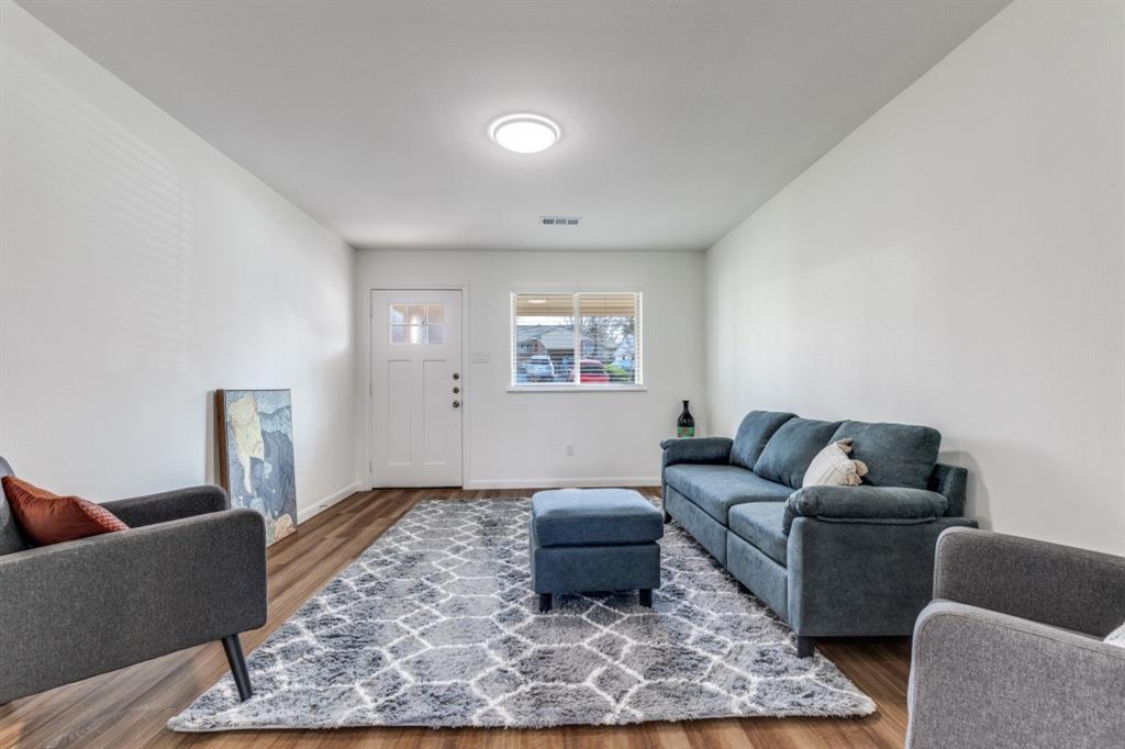 2663 Springvale Drive Farmers Branch, TX 75234 - Photo 5 of 25 a living room with furniture and a rug