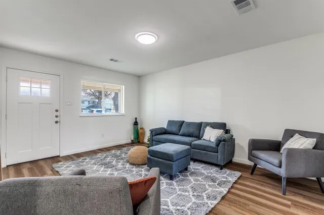 a living room with furniture rug and window