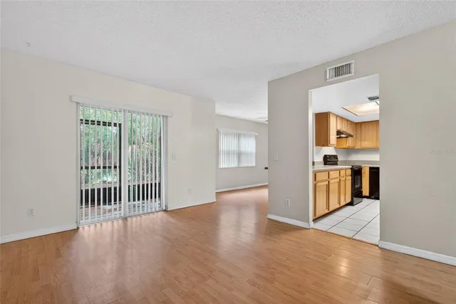 a view of a kitchen with wooden floor and a kitchen
