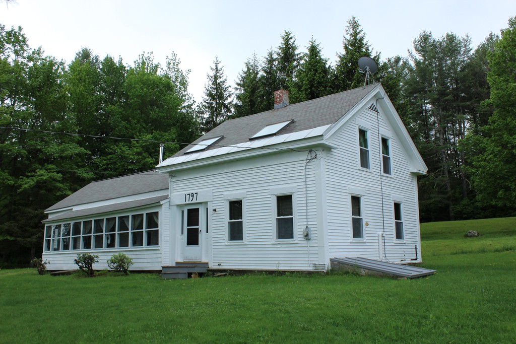 177 Number 9 Road Heath, MA 01367 - Photo 1 of 26 a view of a white house next to a yard with big trees