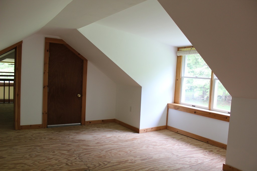 177 Number 9 Road Heath, MA 01367 - Photo 21 of 26 a view of an empty room with wooden floor and a window