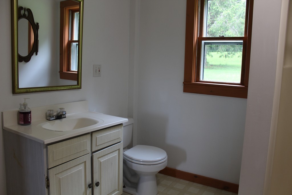 177 Number 9 Road Heath, MA 01367 - Photo 24 of 26 a bathroom with a toilet sink and mirror