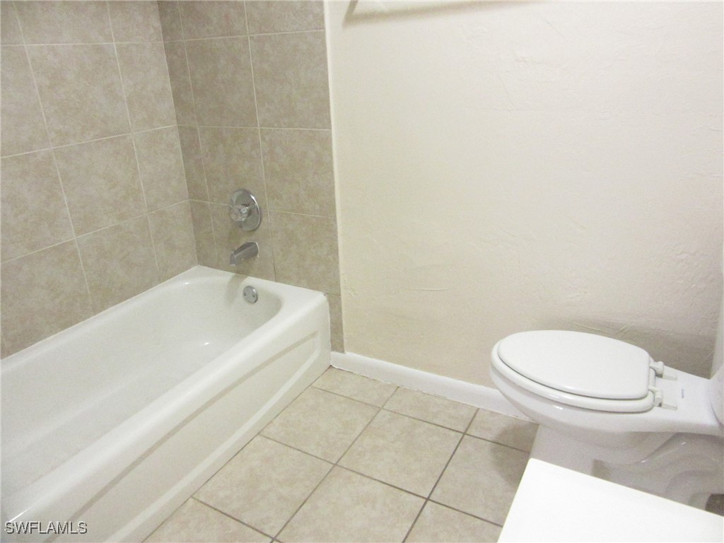 3215 Skyline Boulevard, Unit C Cape Coral, FL 33914 - Photo 17 of 25 a white toilet sitting next to a bath tub