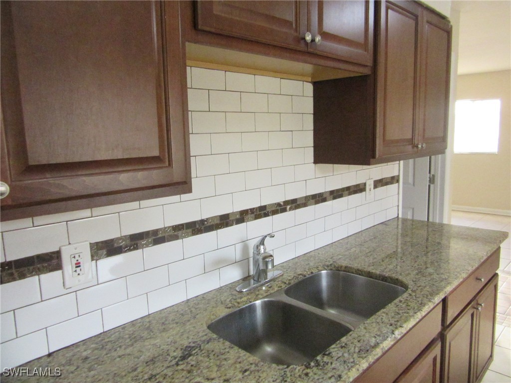 3215 Skyline Boulevard, Unit C Cape Coral, FL 33914 - Photo 20 of 25 a kitchen with a sink and cabinets