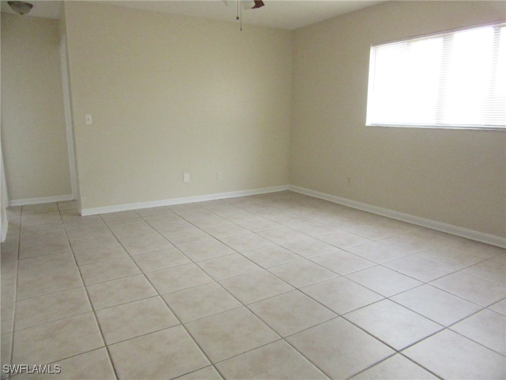 3215 Skyline Boulevard, Unit C Cape Coral, FL 33914 - Photo 8 of 25 an empty room with a window