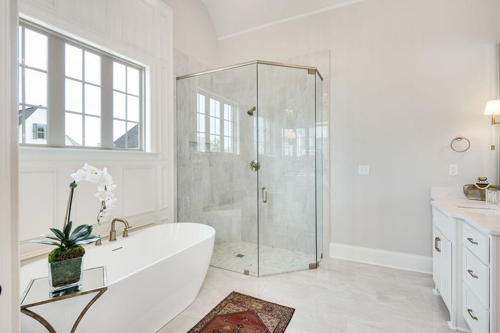 597 Cedar Shadows Circle West Collierville, TN 38017 - Photo 23 of 36 a bathroom with a tub sink and mirror