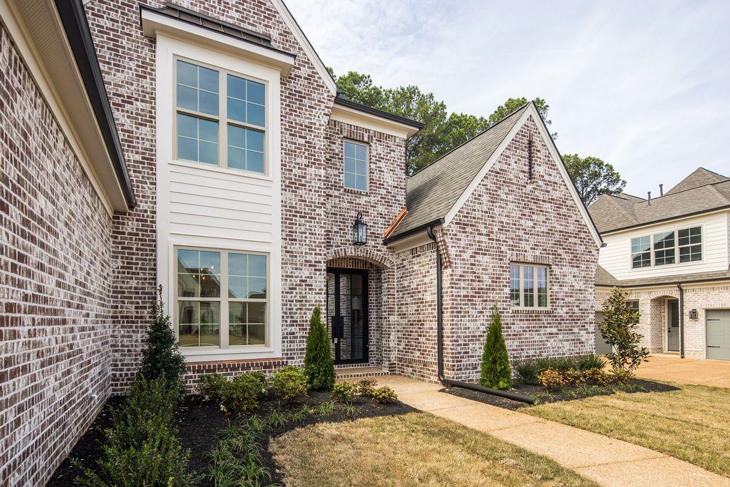 597 Cedar Shadows Circle West Collierville, TN 38017 - Photo 5 of 36 a view of a brick house with many windows