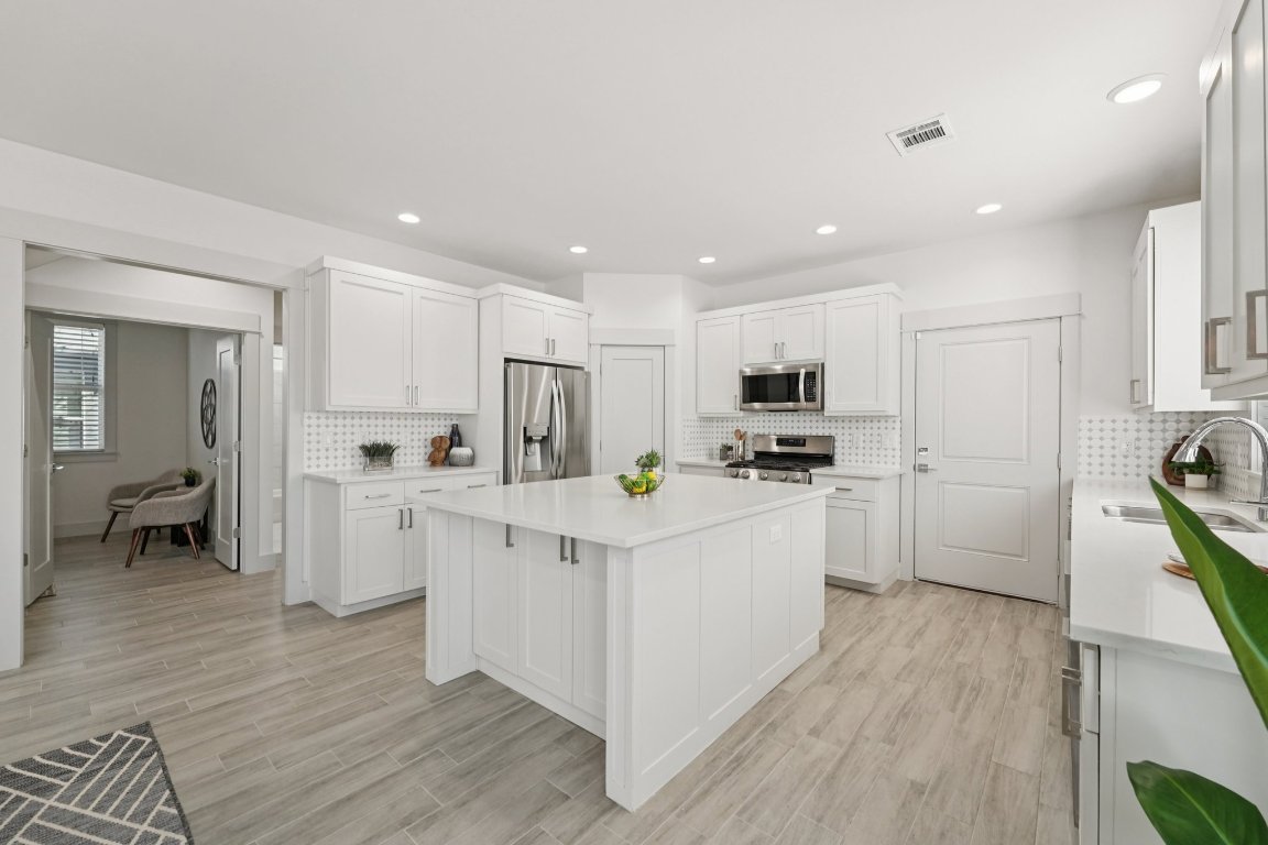 3711 Cedar Street Austin, TX 78705 - Photo 11 of 40 a kitchen with white cabinets and stainless steel appliances