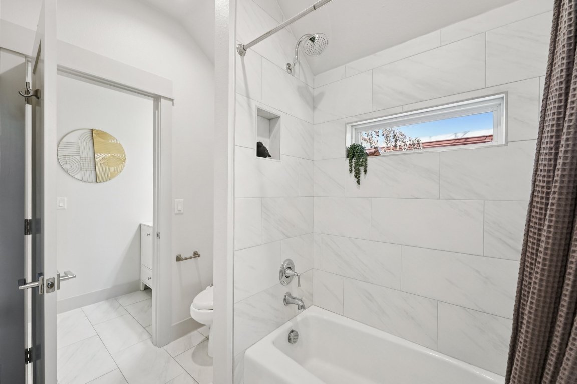 3711 Cedar Street Austin, TX 78705 - Photo 27 of 40 a bathroom with a shower a toilet and a shower