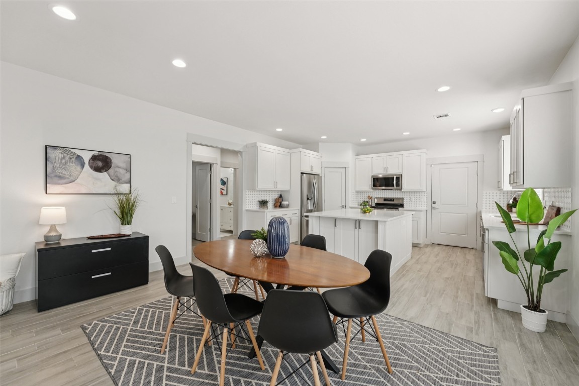 3711 Cedar Street Austin, TX 78705 - Photo 4 of 40 a dining room with kitchen island a stove a table and chairs