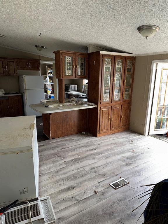 2525 Shiloh Road, Unit 240 Tyler, TX 75703 - Photo 7 of 18 a large kitchen with stainless steel appliances wooden floor and a refrigerator