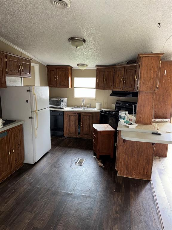 2525 Shiloh Road, Unit 240 Tyler, TX 75703 - Photo 9 of 18 a kitchen with kitchen island granite countertop a sink cabinets and wooden floor