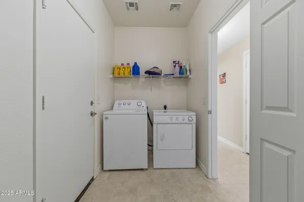 a view of an empty room with shelves and a window