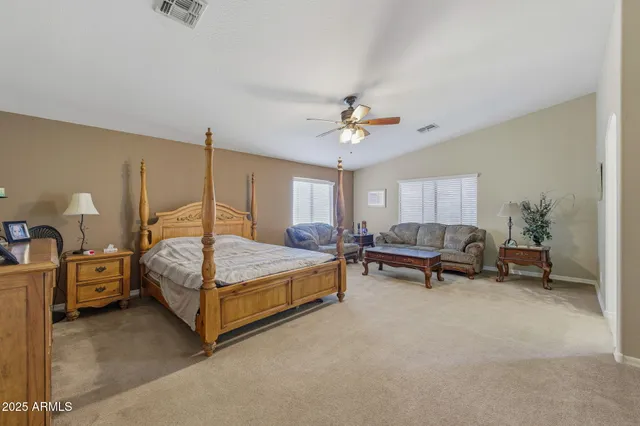 a bedroom with furniture and a chandelier