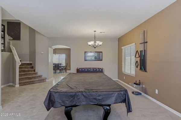 a room with furniture pool table and wooden floor