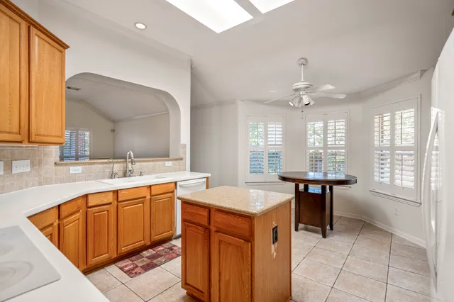 a kitchen with a sink a counter top space and appliances