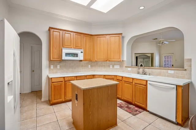 a kitchen with stainless steel appliances granite countertop a sink and cabinets