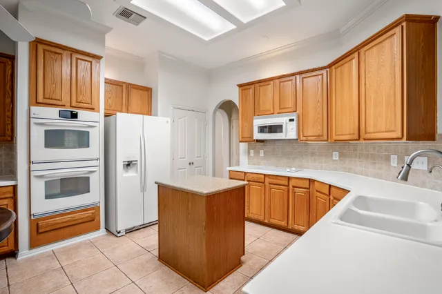a kitchen with stainless steel appliances granite countertop a refrigerator sink and cabinets