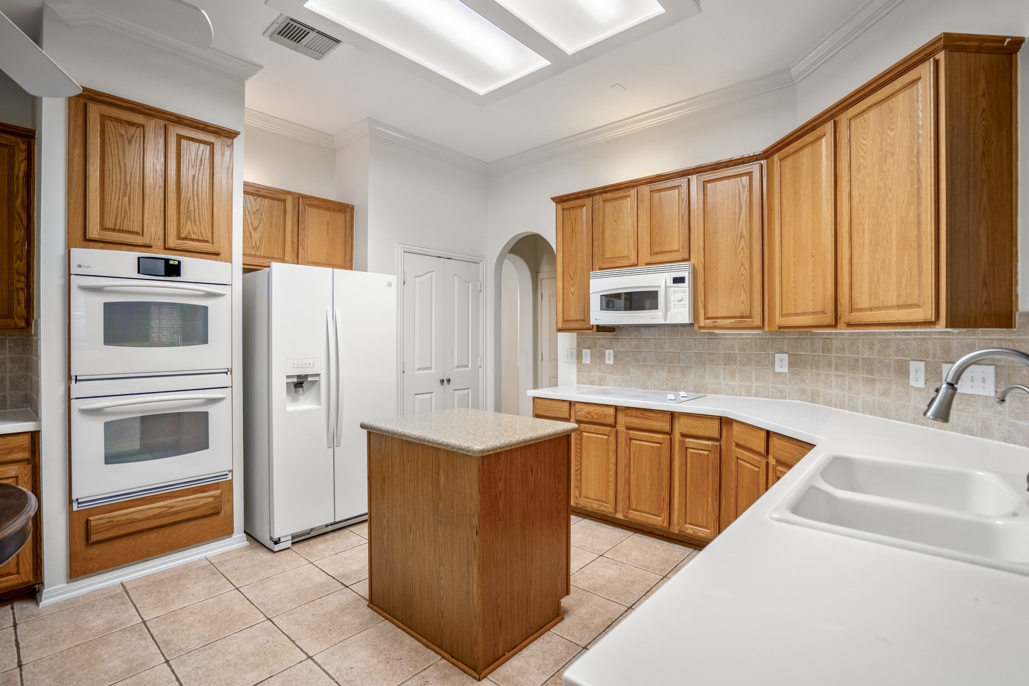 15 Heron Hollow Court Spring, TX 77382 - Photo 13 of 42 a kitchen with stainless steel appliances granite countertop a refrigerator sink and cabinets